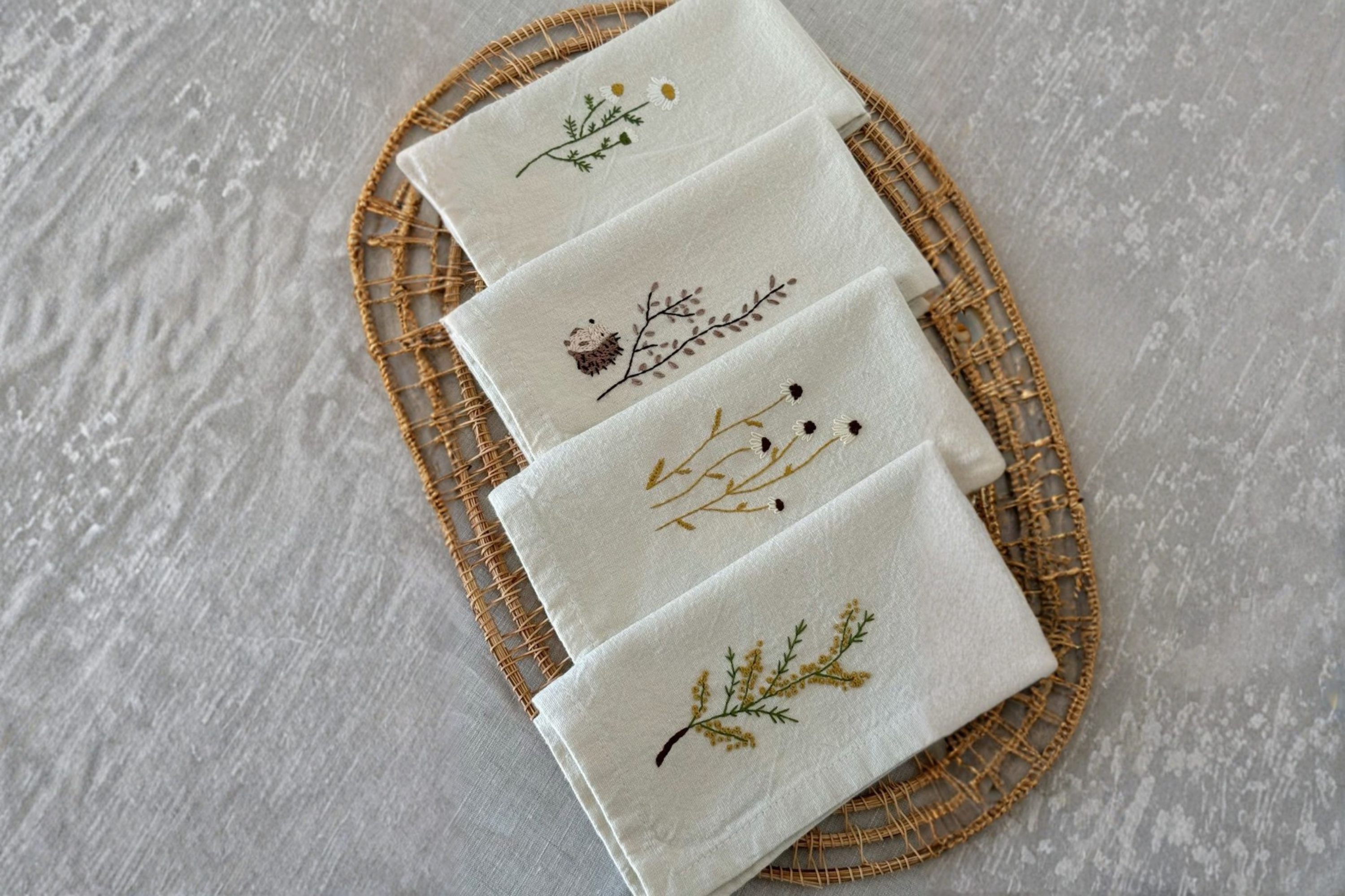Delicate embroidered linen handkerchiefs with floral patterns for wedding souvenirs.