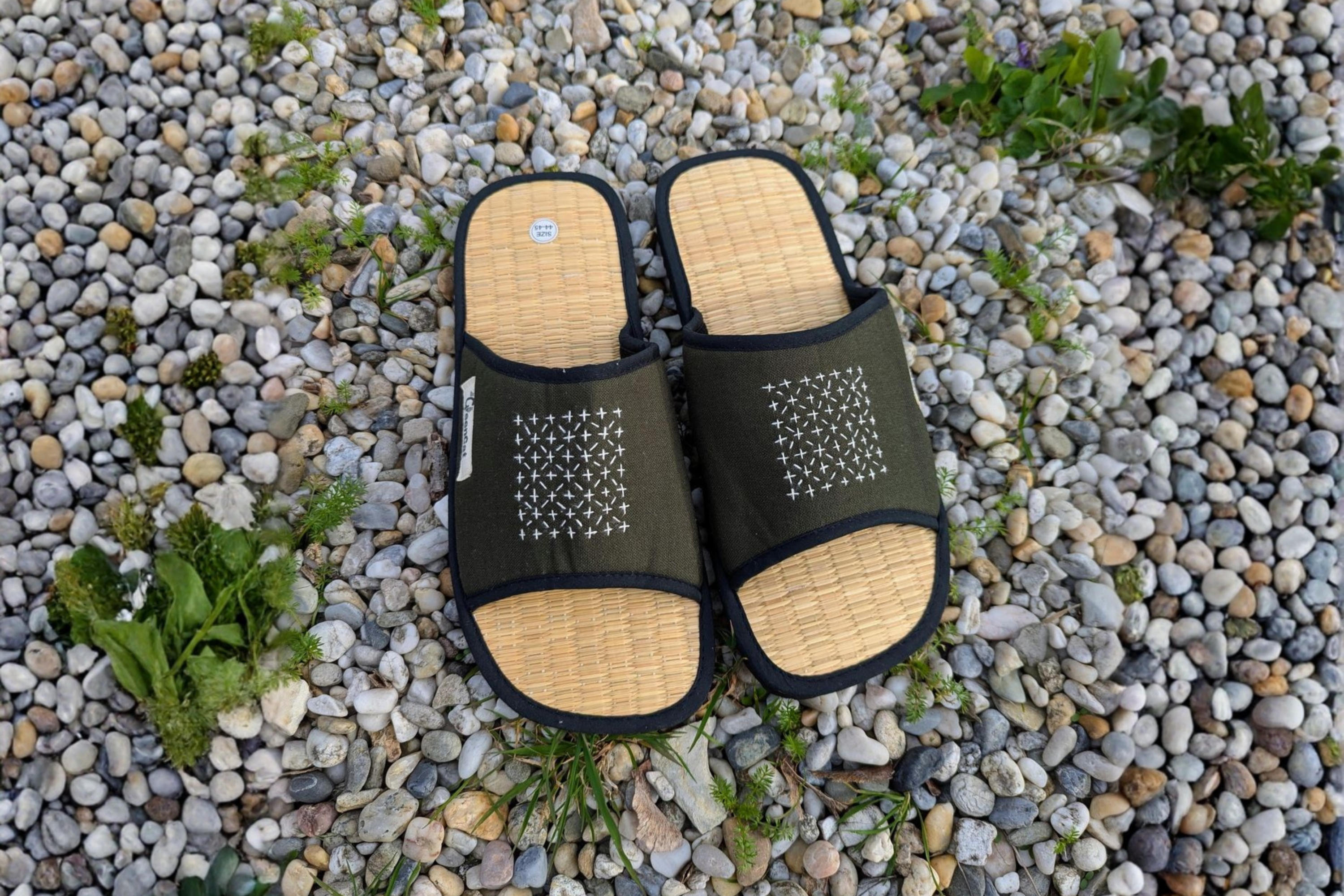 Handcrafted natural seagrass slippers, perfect for beach wedding guest comfort.