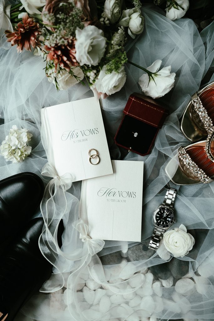 Vow books, wedding bands, a Cartier ring box, and carefully chosen accessories — the details that set the tone before the ceremony began.