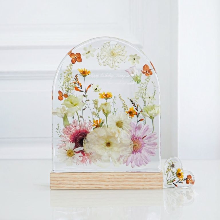 Preserved wildflower arrangement in an arched resin dome with wooden base
